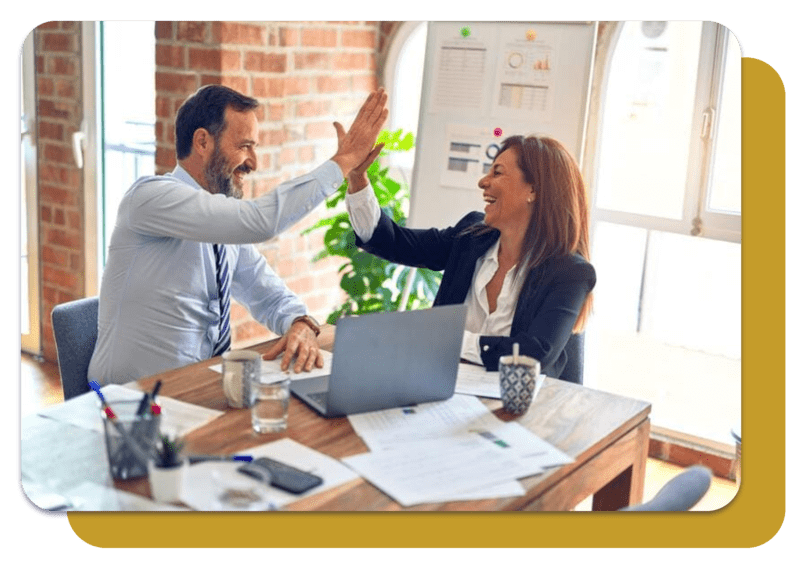 two business partners exchanging high fives